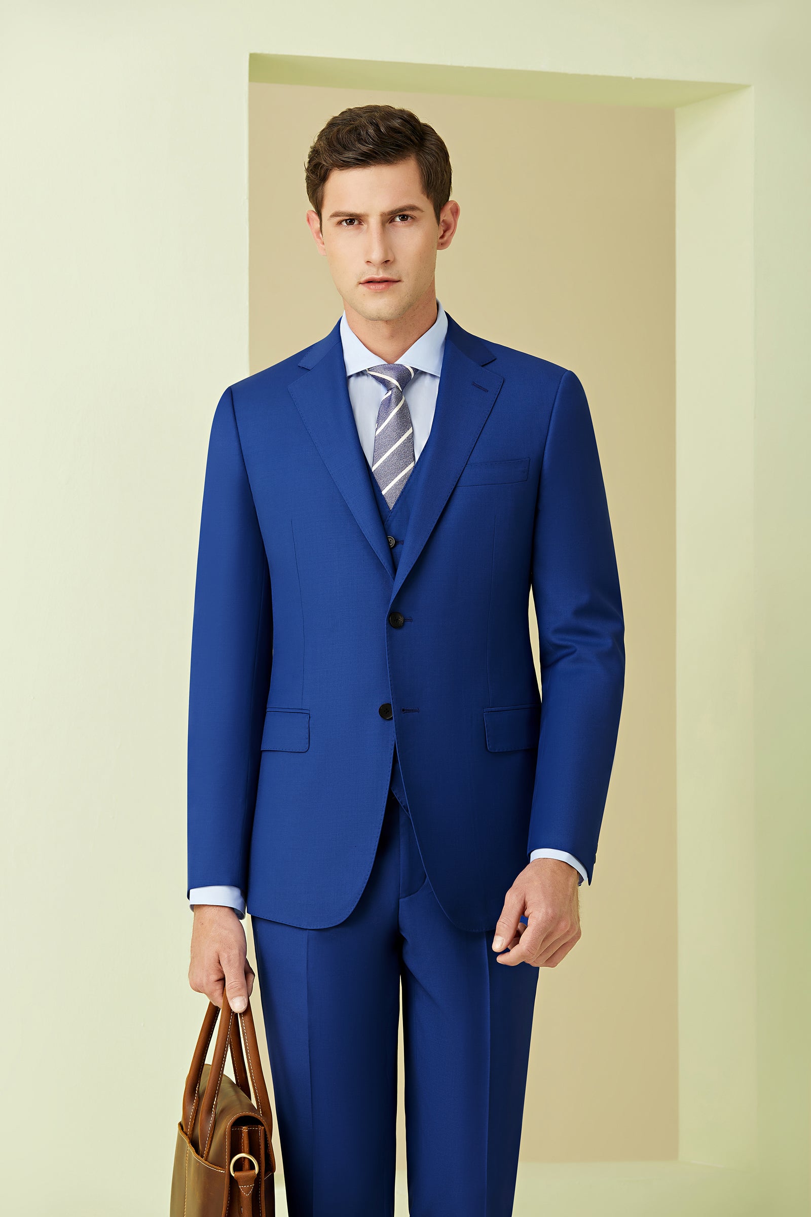 A man wearing a blue 3 piece suit